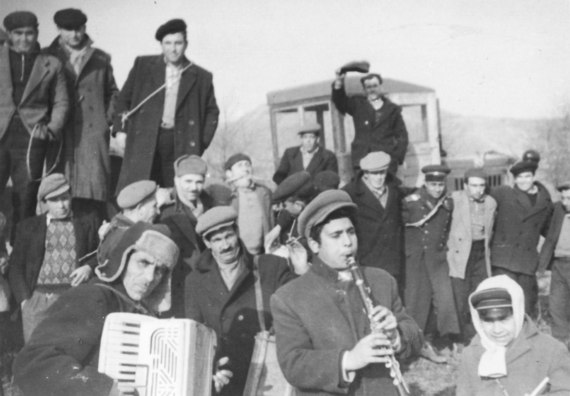 An archive photograph of family musicians with an accordion and a clarinet
