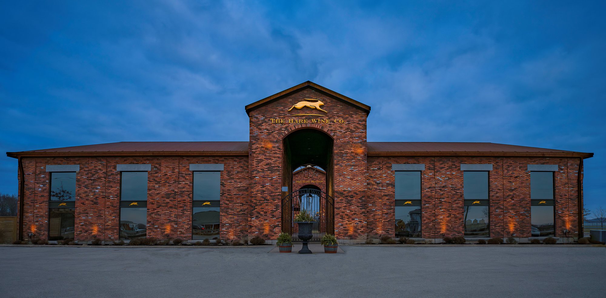 The Hare Wine Co. at dusk, the gold hare above its brick frontage