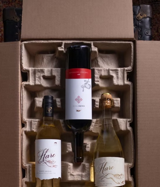 Three bottles packed in a moulded shipping box, ready to go out to members
