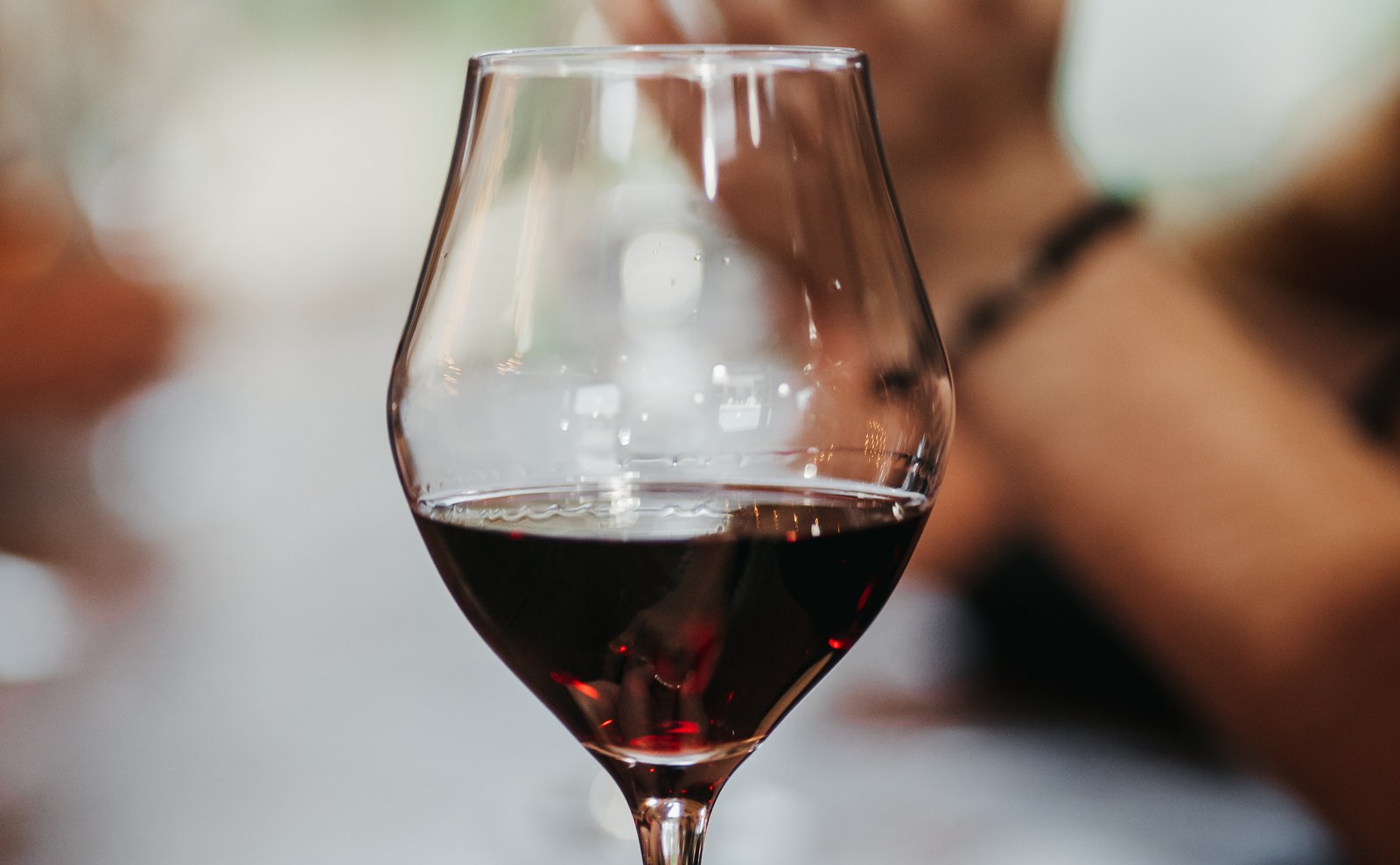 A glass of red wine held up to the light