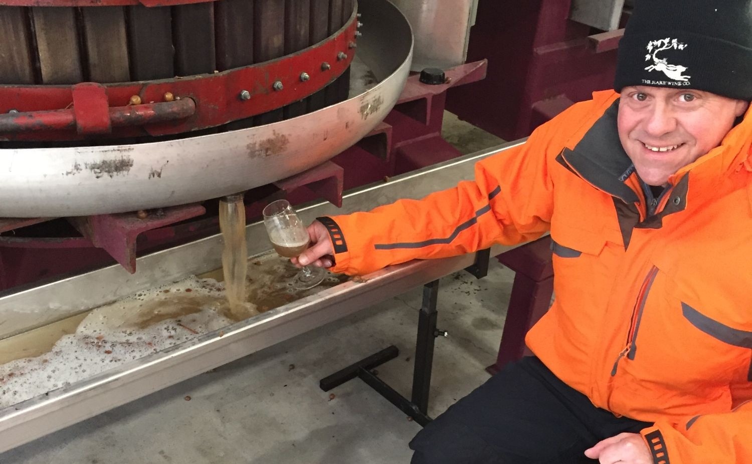 John Hare at the press during the icewine harvest, glass in hand